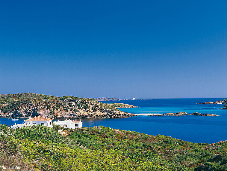 Blick über eine Bucht mit blauem Meer im Hintergrund