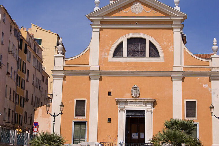 Blick auf eine kleine Kirche mit Palmen im Vordergrund